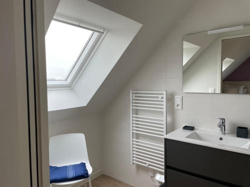 a bathroom with a sink and a window at Villa Beau Séjour in Fontenay-sur-Mer