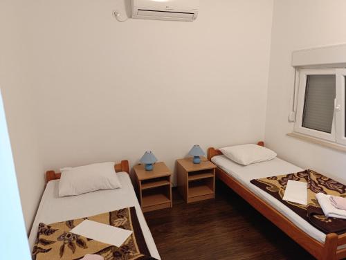 a room with two beds and a window at Guest House Robi in Međugorje