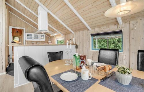 a dining room and kitchen with a table and chairs at Holiday Home Vestertoften in Høruphav