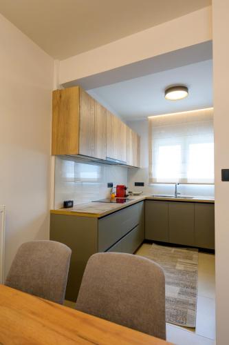 a kitchen with a table and two chairs and a sink at Next Vision Residence in Anatolí