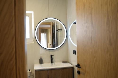 a bathroom with a sink and a mirror at Next Vision Residence in Anatolí