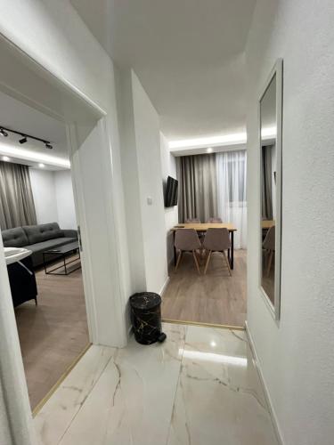 a hallway with a living room and a dining room at Apartman Kosuta Lux Mountain View in Tjentište