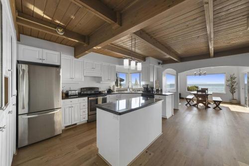 a kitchen with white cabinets and a view of the ocean at New Beautiful Waterfront at Sandy Point in Ferndale