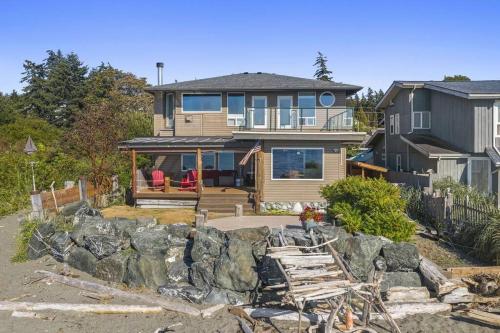 a large house with a stone wall in front of it at New Beautiful Waterfront at Sandy Point in Ferndale