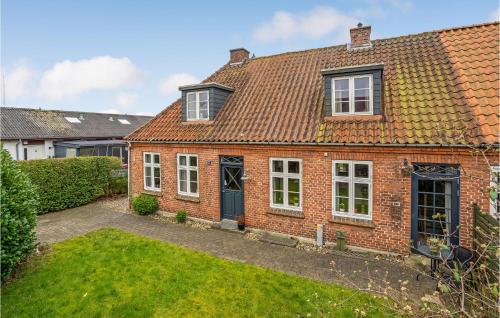 a red brick house with white windows and a yard at Lovely Home In Sønderborg With Kitchen in Sønderborg
