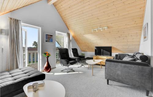 a living room with a couch and chairs and a television at Lovely Home In Gråsten With Wifi in Gråsten