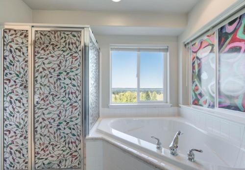a white bathroom with a tub and a window at *NEW* Sunset Ridge Marysville 5 Beds 4 Baths in Marysville