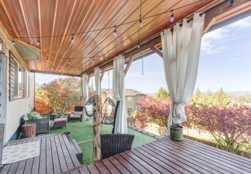 a porch with a wooden deck with chairs and awning at *NEW* Sunset Ridge Marysville 5 Beds 4 Baths in Marysville