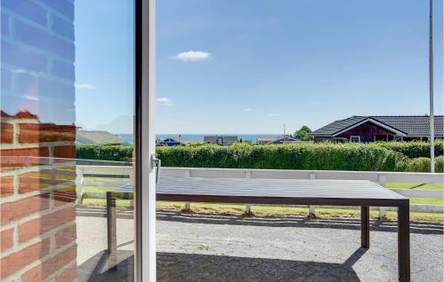 a bench sitting in front of a glass door at Holiday Home Bygmarken Sjølund Xii in Sjølund