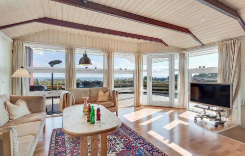 a living room with a couch and a table at Holiday Home Hvedemarken Sjølund Vi in Hejls