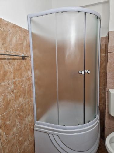 a shower with a glass door in a bathroom at EVA Studio Eforie Nord in Eforie Nord