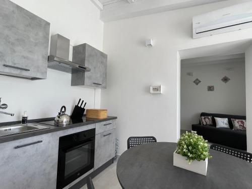 a kitchen and living room with a table and a couch at Maison Divaga in Fleri