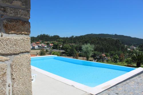 a swimming pool in a villa with a view at CASA DAS QUINTÃES in Figueiredo