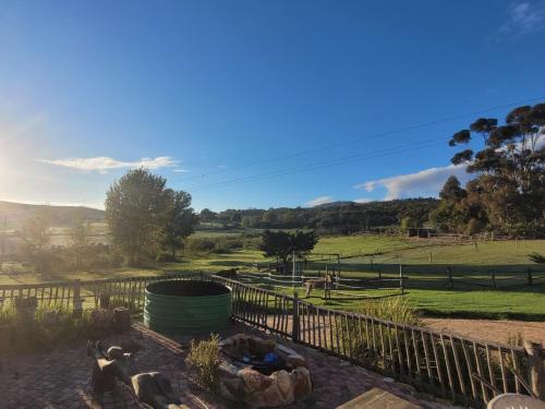 a view of a farm with animals in a field at Kleinwatervalplaas Farm Stay Accomodation in Caledon