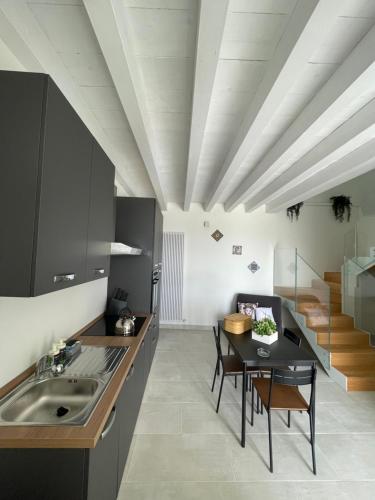 a kitchen with a sink and a table with chairs at Maison Divaga in Fleri