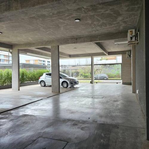 a car parked in an empty parking lot at Moderno departamento Condo SUITE c cochera in Rosario