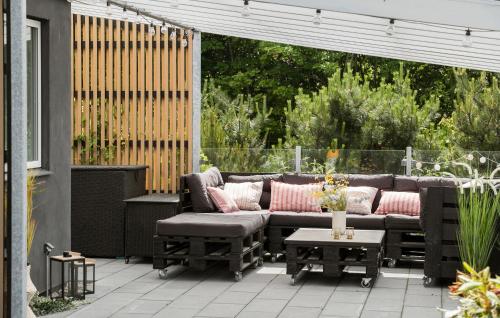 a patio with a couch and a table at 2 Bedroom Beautiful Home In Fårevejle in Fårevejle