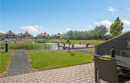 a park with a pond and houses in the background at 2 Bedroom Gorgeous Apartment In Bogense in Bogense
