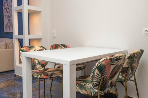 a white table with four chairs around it at Poseidon 5 in Paralia Katerinis