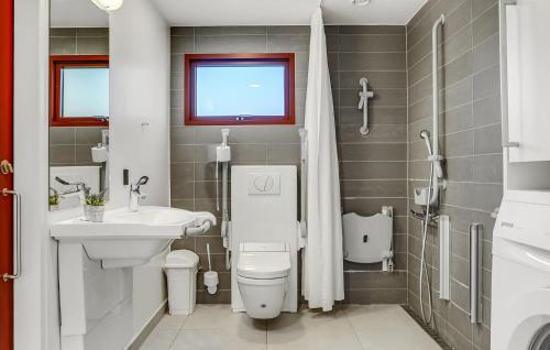 a bathroom with a white toilet and a sink at Gorgeous Home In Grenaa With Wifi in Grenå