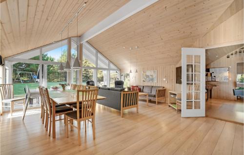 a dining room and living room with a table and chairs at Holiday Home Dyssebjergvej Rømø Denm in Rømø Kirkeby
