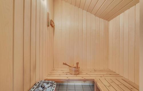 a sauna with a sink and a tub in it at Holiday Home Drejet Rudkøbing V in Spodsbjerg