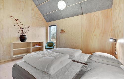 a bedroom with a large bed and a vase on the wall at 3 Bedroom Gorgeous Home In Silkeborg in Silkeborg