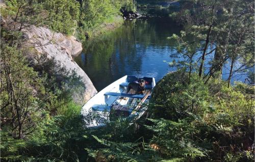 a boat in the middle of a river at Holiday Home Lilla Edet in Lilla Edet