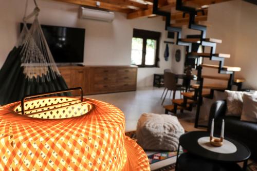 a living room with a hammock in the middle of a room at Sunset Home in Vršac