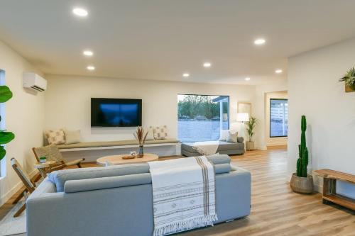 a living room with a blue couch and a tv at Villa Yoku By The Cohost Company in Yucca Valley