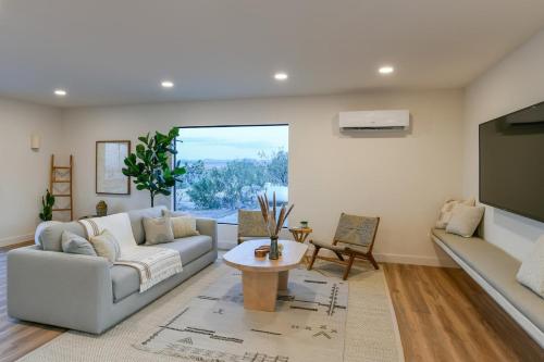 a living room with a couch and a table at Villa Yoku By The Cohost Company in Yucca Valley
