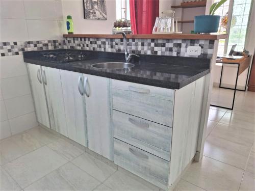 a kitchen with a sink and a counter top at Northwest Hostings 301 in Cartagena de Indias