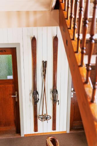 a room with skis on the wall next to a staircase at Pilgerhaus Maria-Rickenbach - Anreise nur via Luftseilbahn möglich in Dallenwil