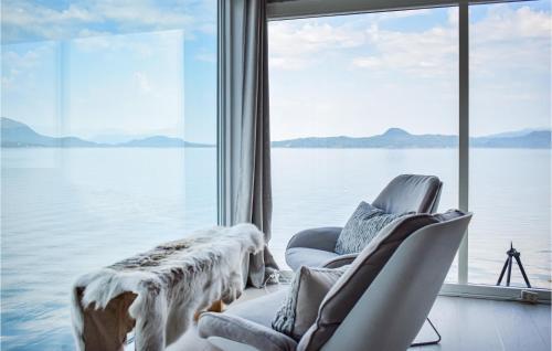a room with two chairs and a large window at Lovely Home In Skånevik in Skånevik