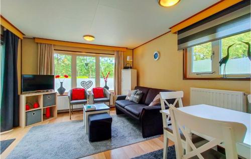a living room with a couch and a table at Gorgeous Home In Schoonloo With Wifi in Schoonloo