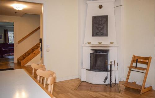 a living room with a fireplace and a staircase at Beautiful Home In Tingsryd With Sauna in Tingsryd
