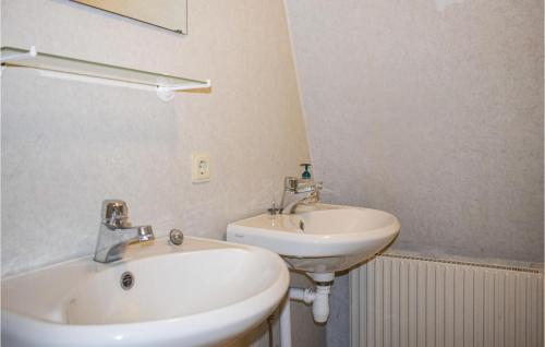 a bathroom with a white sink and a mirror at Beautiful Home In Tingsryd With Sauna in Tingsryd
