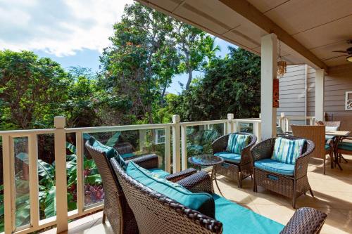 a porch with wicker chairs and a table at Cool & Quiet Wailea Oasis, Big Lanai + Two Pools in Wailea