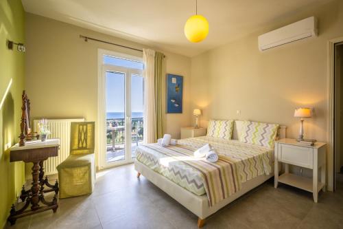 a bedroom with a bed with a view of the ocean at Liogerma Art Deco Villa - 5 min drive to Lassi in Sarlata