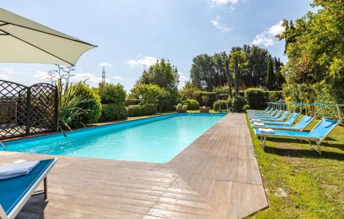 a swimming pool with lounge chairs and an umbrella at Villa Elena in Barbaricina