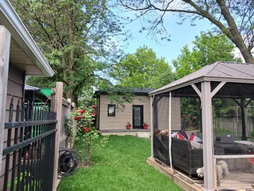 a gazebo in a yard next to a house at The Grassy Oasis in Brampton
