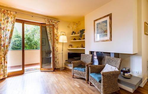 a living room with two chairs and a sliding glass door at Villa Elena in Barbaricina