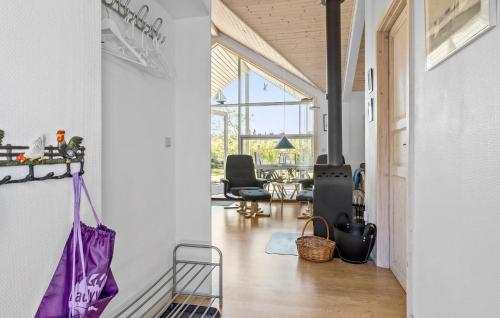 a hallway with a purple bag hanging from a wall at 3 Bedroom Amazing Home In Vestervig in Vestervig