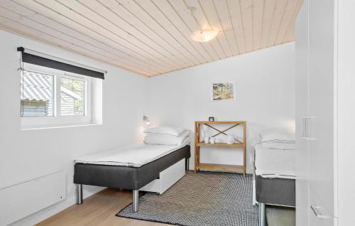 a bedroom with two beds and a window at 3 Bedroom Amazing Home In Vestervig in Vestervig