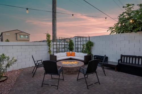 a patio with a couch and chairs and a fire pit at 8BR 5BA SuperHero Retreat-King Beds, BBQ, Hammock, Firepit, MiniGolf, WorkSpace in Las Vegas