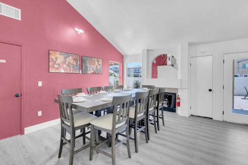 a dining room with a table and chairs at 8BR 5BA SuperHero Retreat-King Beds, BBQ, Hammock, Firepit, MiniGolf, WorkSpace in Las Vegas