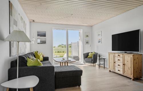 a living room with a couch and a tv at Didde in Ribe