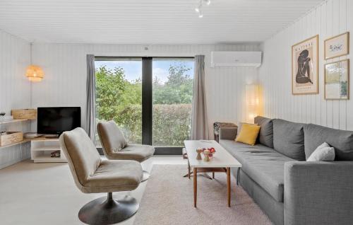 a living room with a couch and two chairs and a tv at 3 Bedroom Cozy Home In Vinderup in Vinderup