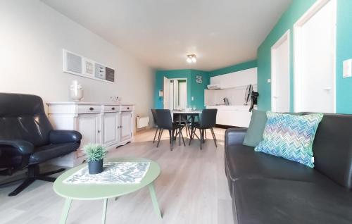 a living room with a couch and a table at Cozy Apartment In Oostende With Wifi in Ostend
