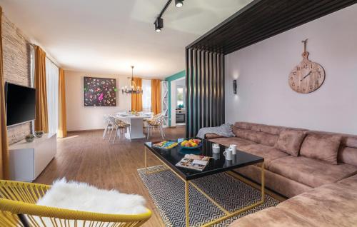 a living room with a couch and a table at 4 Bedroom Cozy Home In Mihatovici in Rošini